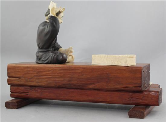 A Japanese ivory, bronze and wood okimono of a carpenter, early 20th century, 32.5cm., some losses